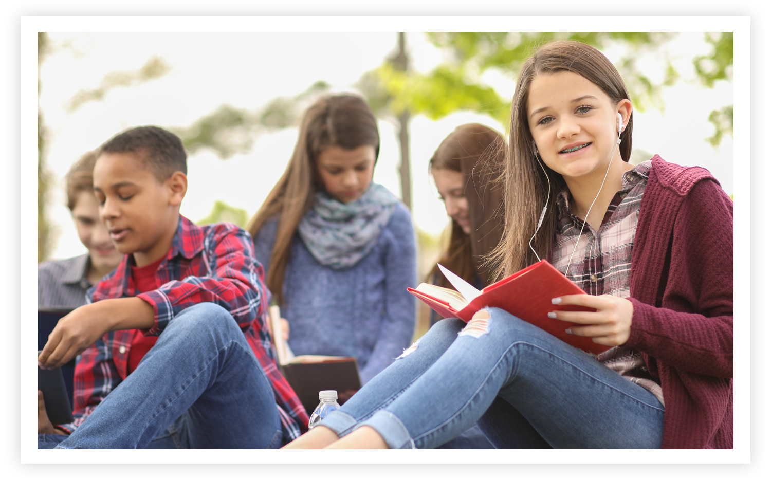 Middle School students reading outside
